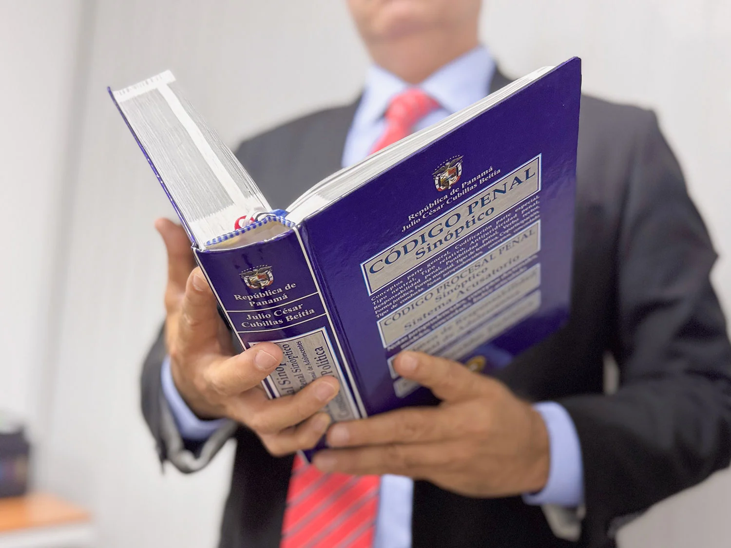 Close-up of Lady Justice statuette held by a lawyer, symbolizing law and justice.