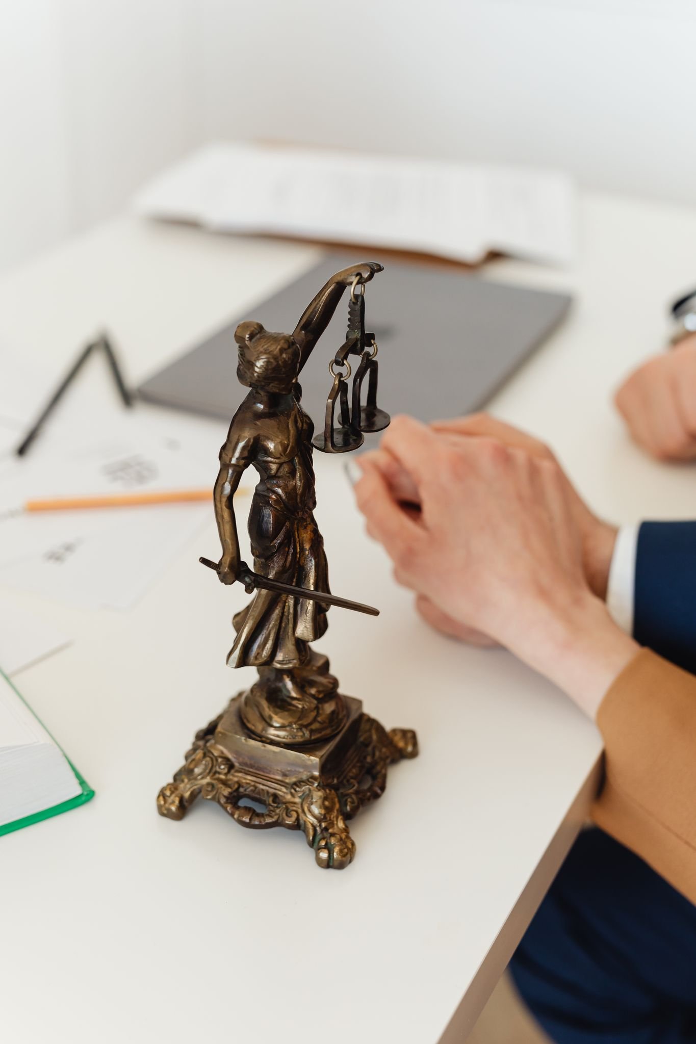 Estatuilla de la Dama de la Justicia sobre un escritorio durante una asesoría de derecho civil